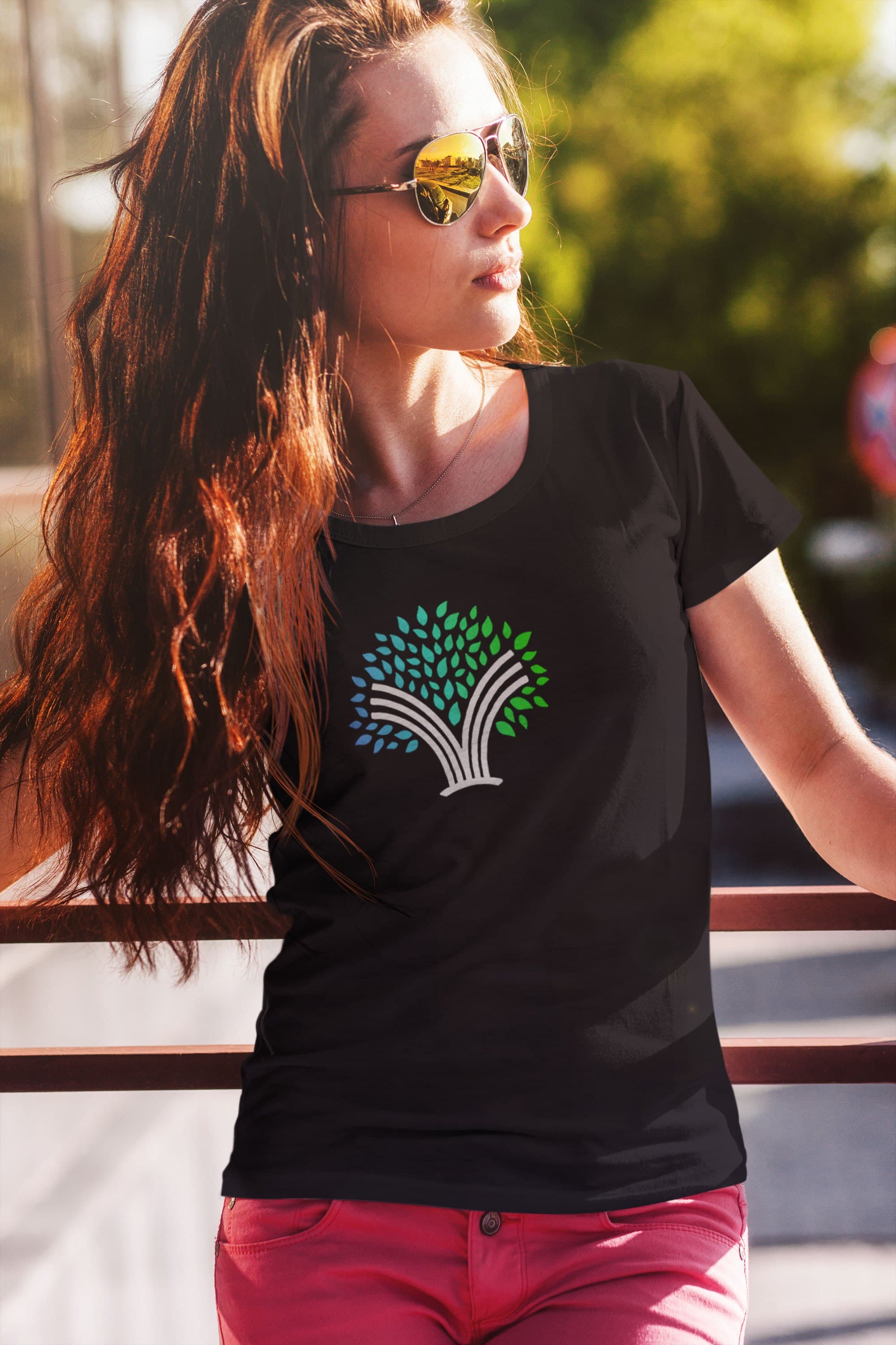 A model wearing a black Invyncible t-shirt with the full-color tree icon