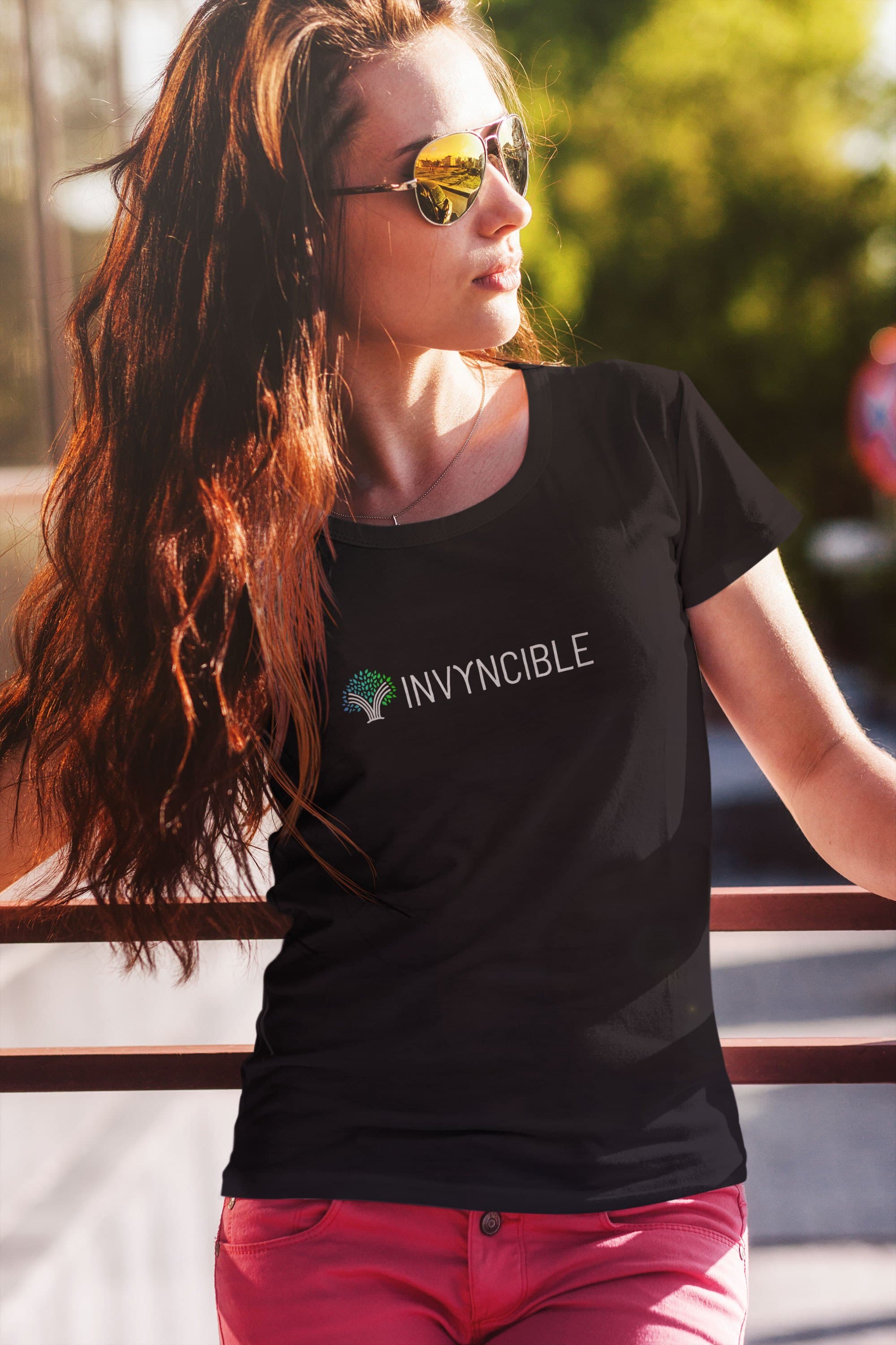 A model wearing a black Invyncible t-shirt with the horizontal logo lockup