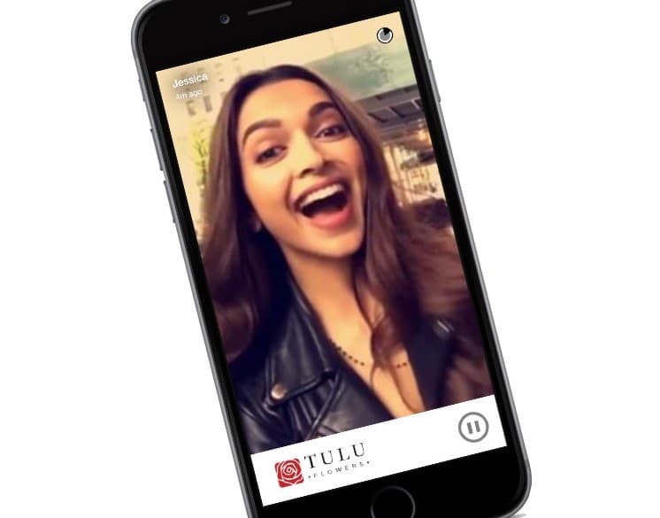 A phone playing a personal video message recorded by the sender, branded Tulu Flowers